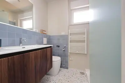 a bathroom with a sink and a toilet and a window at Caracalla Charming Terrace Loft in Rome