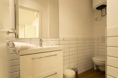a white bathroom with a sink and a toilet at Santa Maria Maggiore & Colosseo - Domus Aurea by Hôtea in Rome