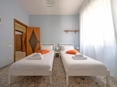 two beds with orange pillows in a room at Welcome to Pigneto in Rome