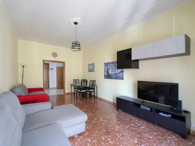 a living room with a couch and a flat screen tv at Welcome to Pigneto in Rome
