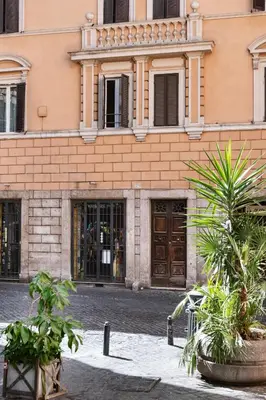 a building with two potted plants in front of it at Leonina Art Loft in Rome