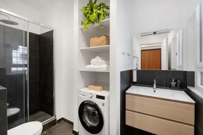 a bathroom with a washing machine and a sink at Leonina Art Loft in Rome