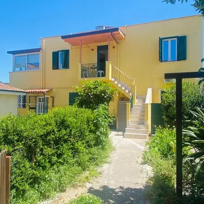 a yellow house with stairs in front of it at Borgo Capua in Rome