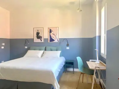 a bedroom with a bed and a desk and a table sidx sidx sidx at Borgo Capua in Rome