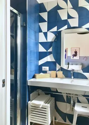 a bathroom with a sink and blue and white tiles at Borgo Capua in Rome