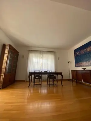 a dining room with a table and chairs in it at Nina House Roma in Rome