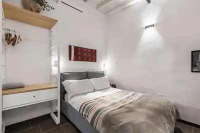 a bedroom with a loft bed and a bathroom at Valentina's studio in Rome