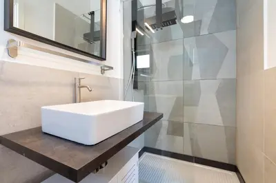 a bathroom with a white sink and a shower at Hill Houses - art & stay - Rome in Rome