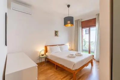 a white bedroom with a bed and a window at Hill Houses - art & stay - Rome in Rome