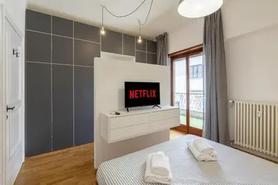 a bedroom with a tv and a bed with towels at Hill Houses - art & stay - Rome in Rome