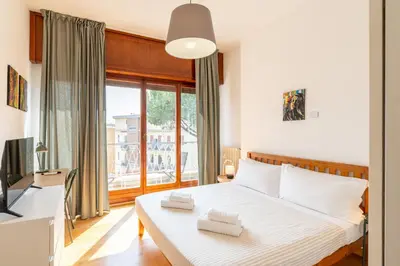 a bedroom with a bed and a large window at Hill Houses - art & stay - Rome in Rome