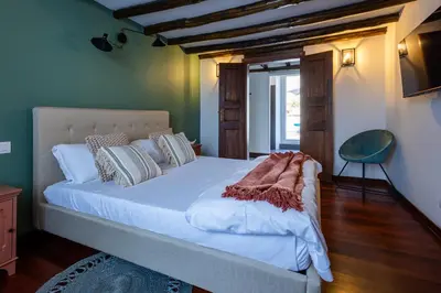 a bedroom with a large white bed in a room at Maria Luxury Apartment with City View Terrace in Rome
