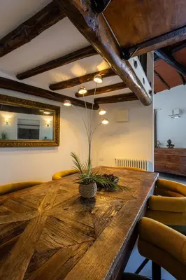 a dining room with a wooden table and chairs at Maria Luxury Apartment with City View Terrace in Rome