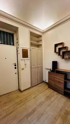 an empty room with a white door and a wooden floor at My house in Rome