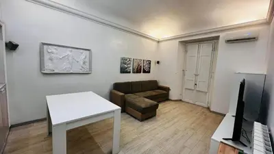 a living room with a couch and a table at My house in Rome