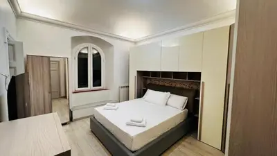 a bedroom with a large white bed in a room at My house in Rome