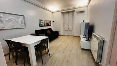 a living room with a white table and a tv at My house in Rome