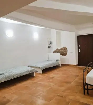 a room with two beds and a wooden floor at Casa Bonosa in the Heart of Rome CISE 25369 in Rome