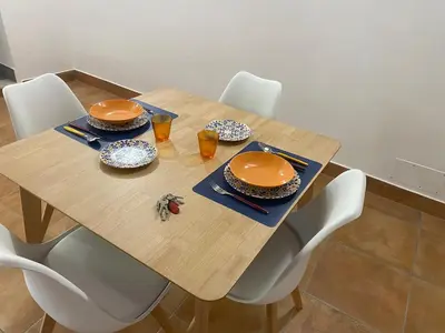 a wooden table with chairs and plates and drinks on it at Casa Bonosa in the Heart of Rome CISE 25369 in Rome