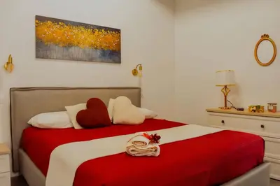 a bedroom with a red and white bed with stuffed animals on it at Trevi Moonlight Apartment in Rome