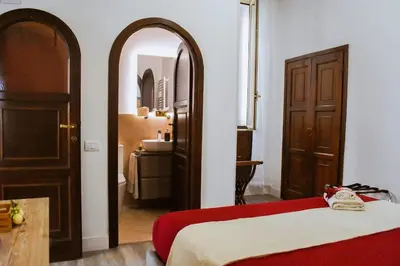 a room with a bed and a mirror and a bathroom at Trevi Moonlight Apartment in Rome