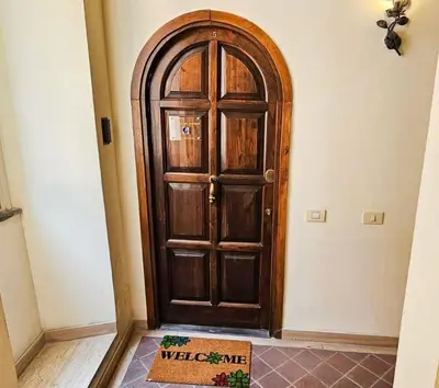 a wooden door in the corner of a room at Trevi Moonlight Apartment in Rome