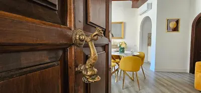 a wooden door with a snake on it in a room at Trevi Moonlight Apartment in Rome
