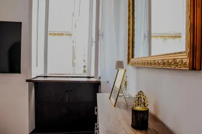 a room with a mirror and a wooden table at Trevi Moonlight Apartment in Rome