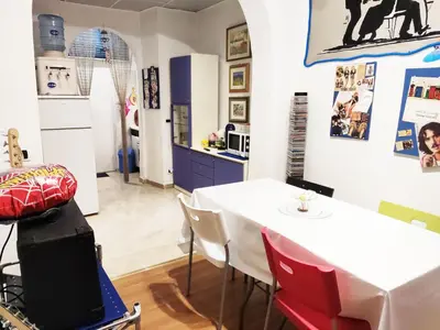 a kitchen and dining room with a white table and chairs at Holiday Jeans Apartment in Rome