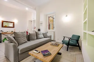a living room with a couch and a table at TrastEva nel cuore di Trastevere a San Cosimato in Rome