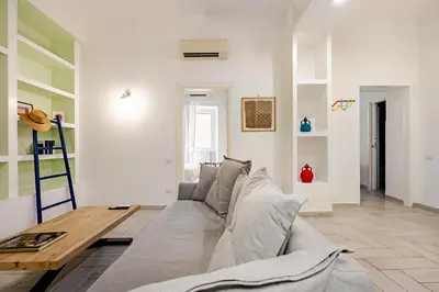 a living room with a couch and a wooden table at TrastEva nel cuore di Trastevere a San Cosimato in Rome