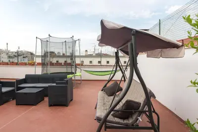 a balcony with a swing and a couch on a roof at Tiburtina Station Rooftop Angel Joy with Private Terrace - Superattico con Terrazzo privato in Rome