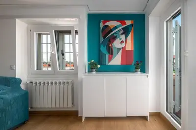a room with a painting of a woman in a hat at Tiburtina Station Rooftop Angel Joy with Private Terrace - Superattico con Terrazzo privato in Rome