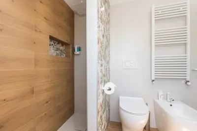 a bathroom with a toilet and a sink at Tiburtina Station Rooftop Angel Joy with Private Terrace - Superattico con Terrazzo privato in Rome