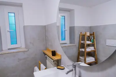 a bathroom with a sink and a mirror at Habemus Casam in Rome