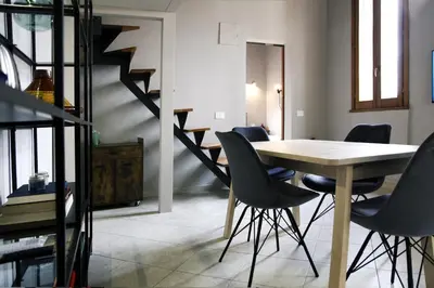 a dining room with a table and chairs and stairs at Rome, very central 2 bedrooms 4 beds in Rome