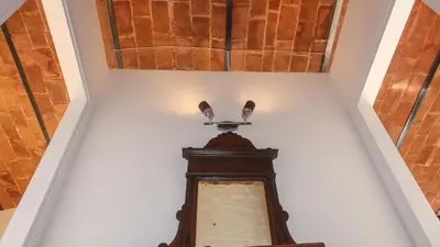 a stairway with a ceiling and a clock at Ostilia Loft in Rome