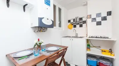a small kitchen with a table and a sink at Ostilia Loft in Rome