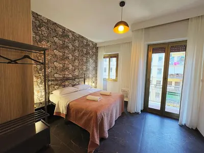 a bedroom with a bed and a wall at LIFEI House in Rome