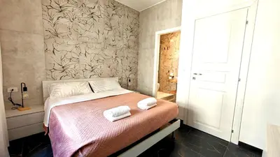 a bedroom with a bed with two towels on it at LIFEI House in Rome