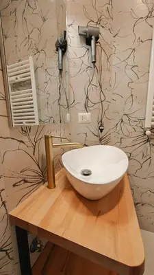 a bathroom with a white sink on a wooden counter at LIFEI House in Rome