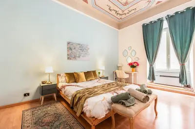 a bedroom with a large bed with blue curtains at The Bright Marajà Roma Centro Luxury Boutique Retreat in Rome