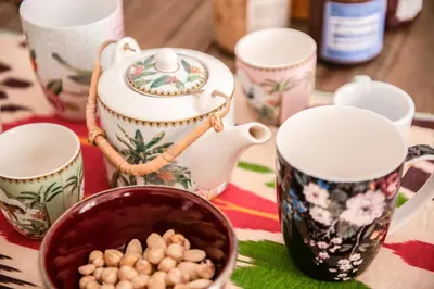 a table topped with cups and a bowl of peanuts at The Bright Marajà Roma Centro Luxury Boutique Retreat in Rome