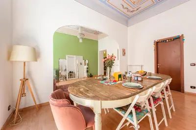 a dining room with a wooden table and chairs at The Bright Marajà Roma Centro Luxury Boutique Retreat in Rome