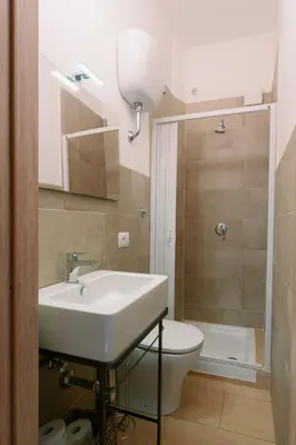 a bathroom with a sink and a toilet at Marilyn Rooms in Rome