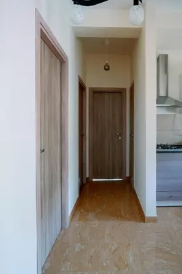 an empty room with a hallway with two doors at Marilyn Rooms in Rome