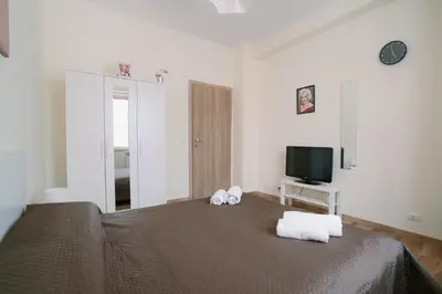 a bedroom with a bed with two towels on it at Marilyn Rooms in Rome