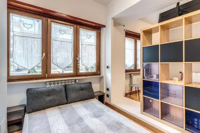 a living room with a couch and windows at VaticanRhome I in Rome