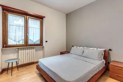 a bedroom with a bed and a window and a stool at VaticanRhome I in Rome