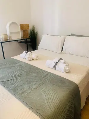 a bedroom with a bed with towels on it at ZAIRA ROMA HOUSE, alloggio per uso turistico in Rome